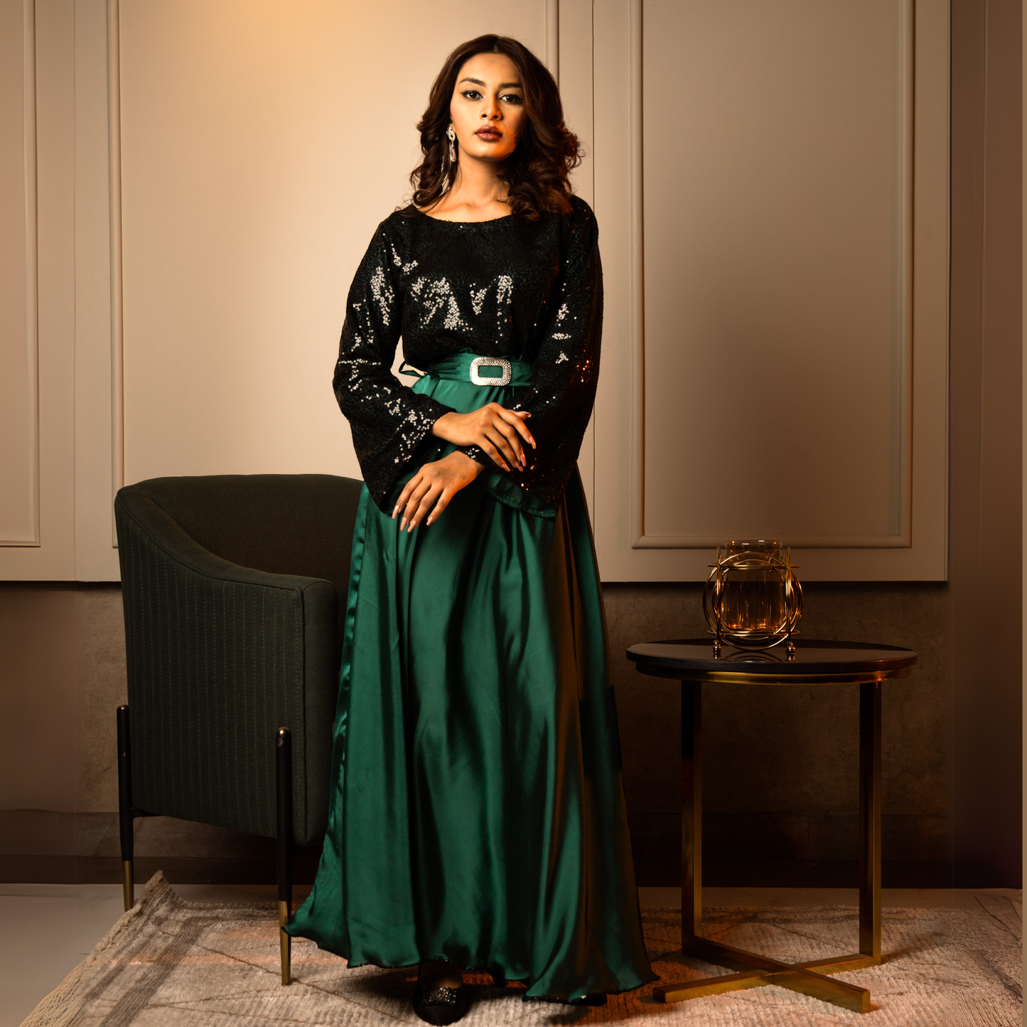 Elegant emerald green evening gown with a sequined bodice, princess seams, and a boat neckline.
