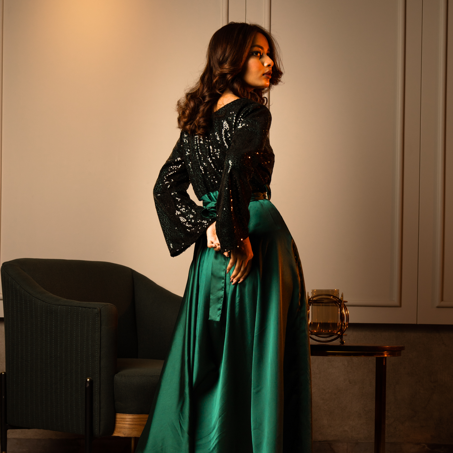 Front view on model: Elegant emerald green evening gown with a sequined bodice, princess seams, and a boat neckline.