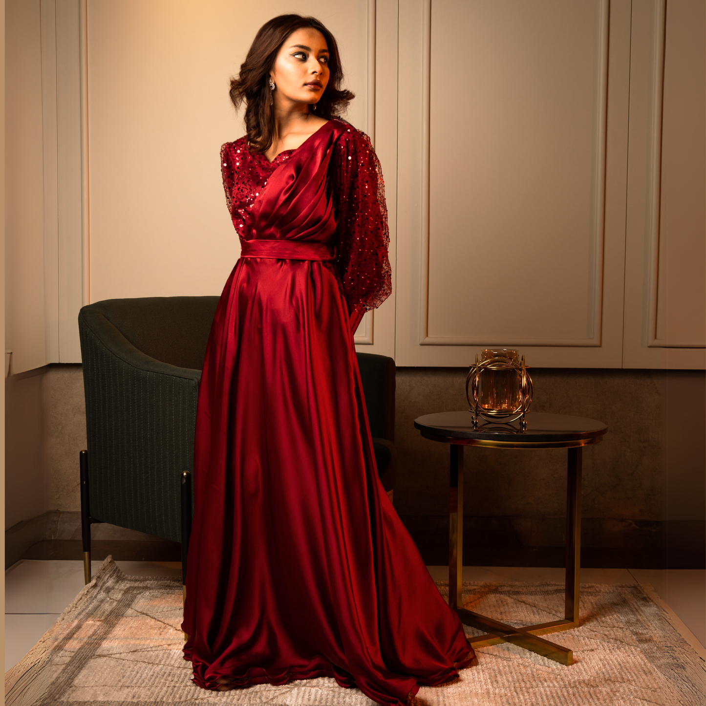 Side view of a red evening gown featuring a fitted waist, princess seams, and a voluminous skirt.